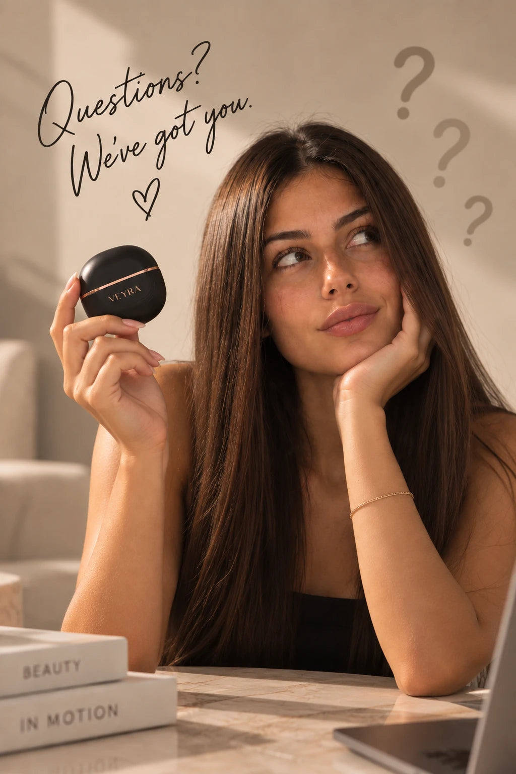 Woman holding the Veyra Go styler — Questions? We've got you